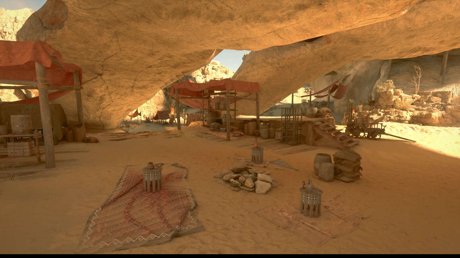 Inside a sand-floored cave, a torch-lit gate leads deeper past a lone tent and fallen banners